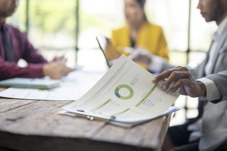 A finance team discussing financial charts at a meeting