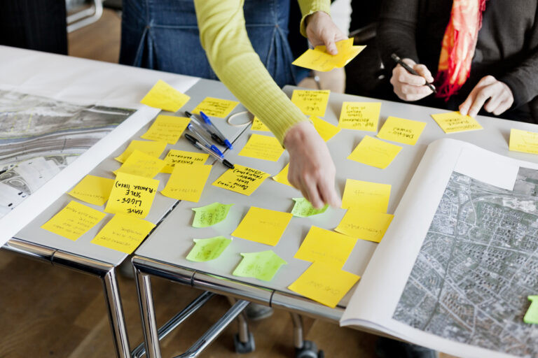 A team sorting problems and ideas on sticky notes during an OKR planning session