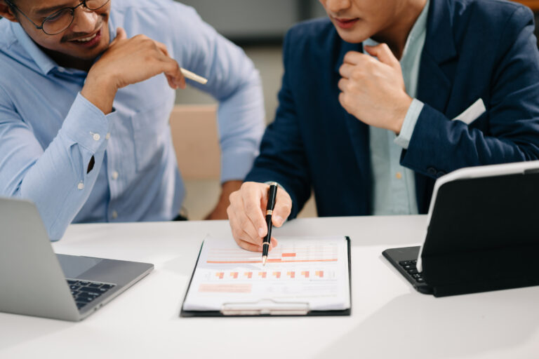 An operations lead reviewing performance charts with a colleague