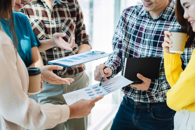 A sales team reviewing pipeline reports together